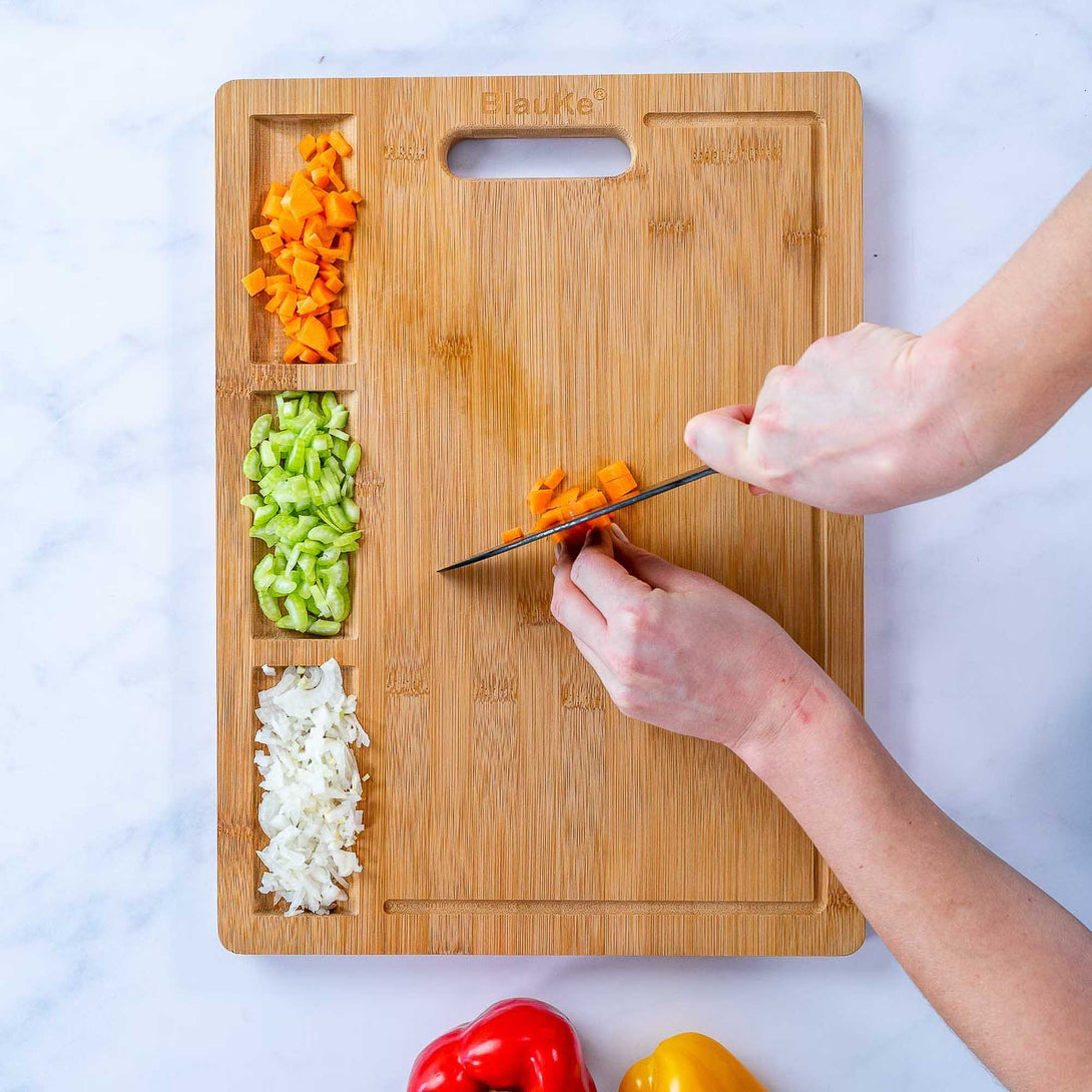 https://blauke.com/cdn/shop/products/WoodenCuttingBoardsforKitchen_ExtraLargeBambooCuttingBoardwithContainers_LargeWoodCuttingBoard-21.1-Enhanced.jpg?v=1678542100&width=1090
